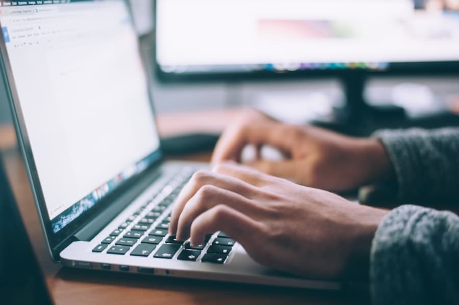 Hands typing on a laptop in a focused work setting